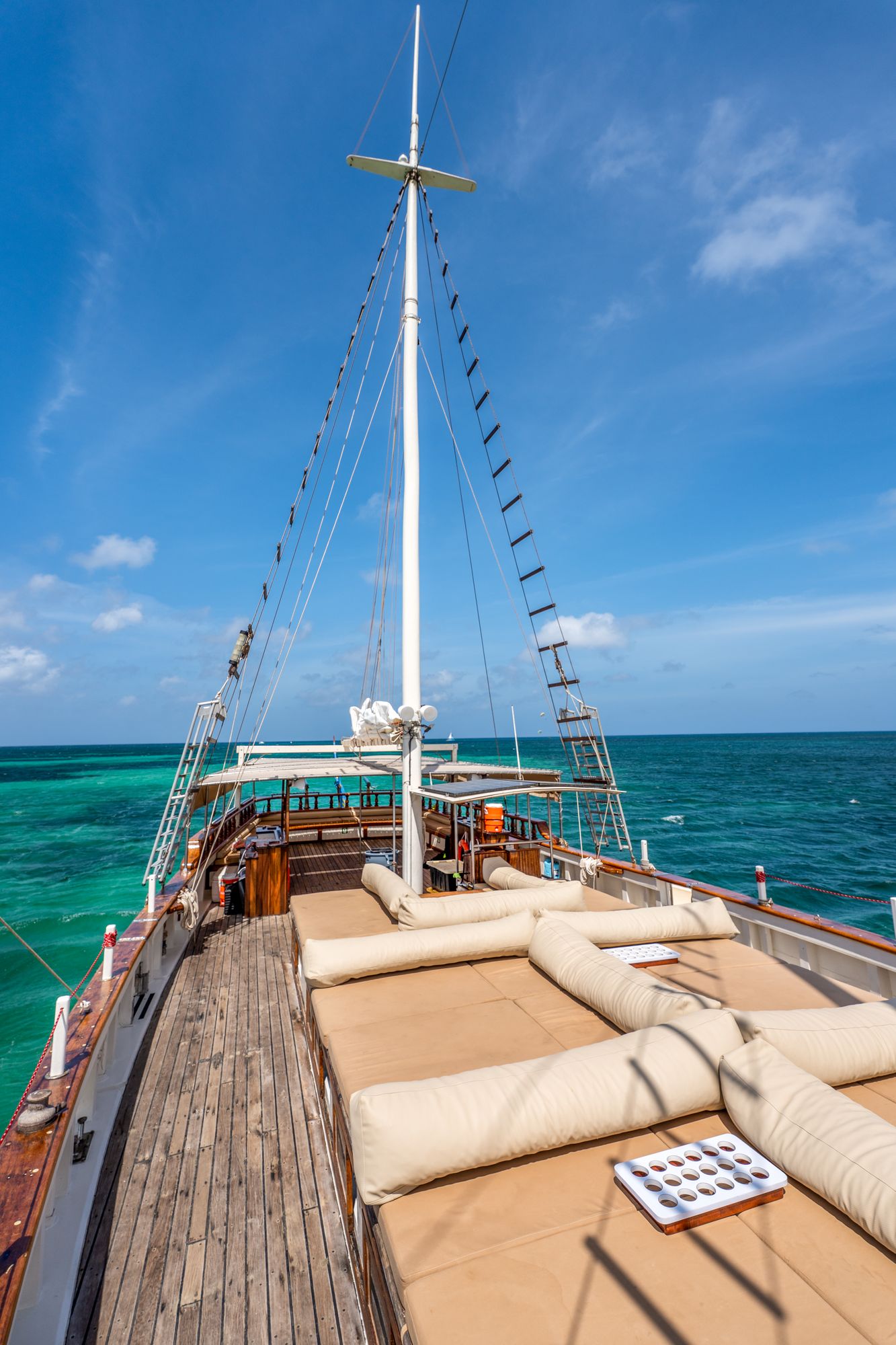 The empty bow deck of the Flagship with sun cushions under the main mast